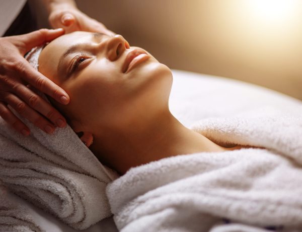Calm girl having spa facial massage in luxurious beauty salon